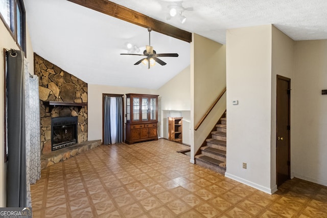 unfurnished living room featuring beamed ceiling, ceiling fan, a stone fireplace, and high vaulted ceiling