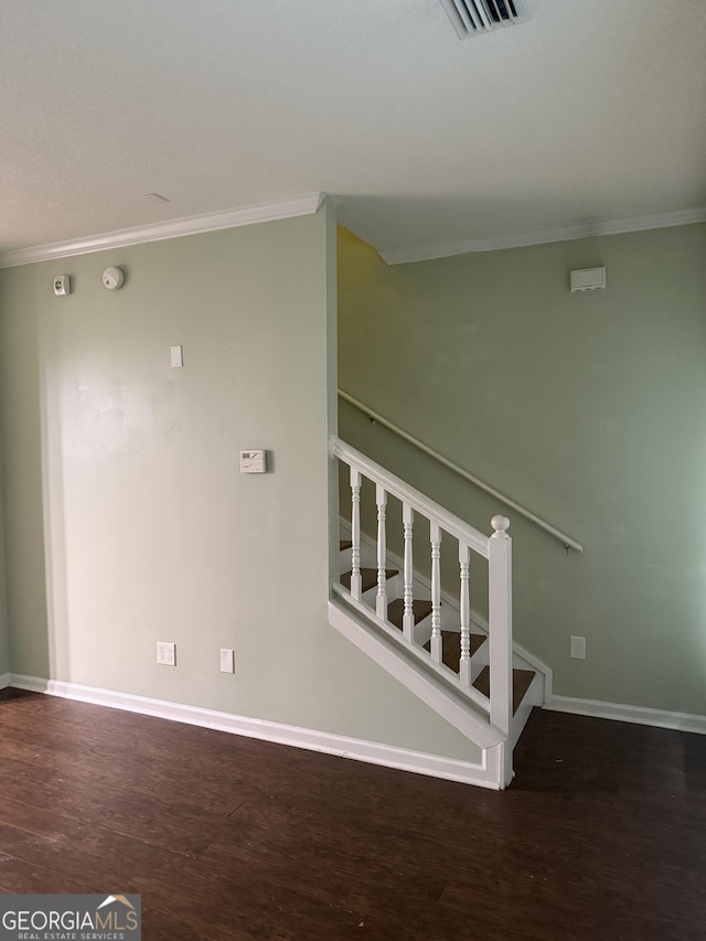 stairway featuring wood-type flooring and crown molding