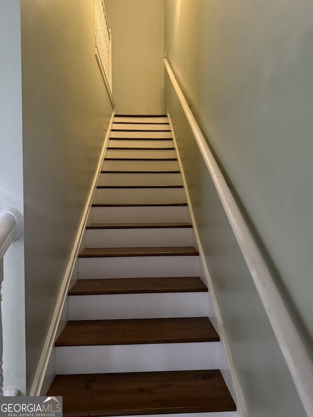 stairway with hardwood / wood-style floors