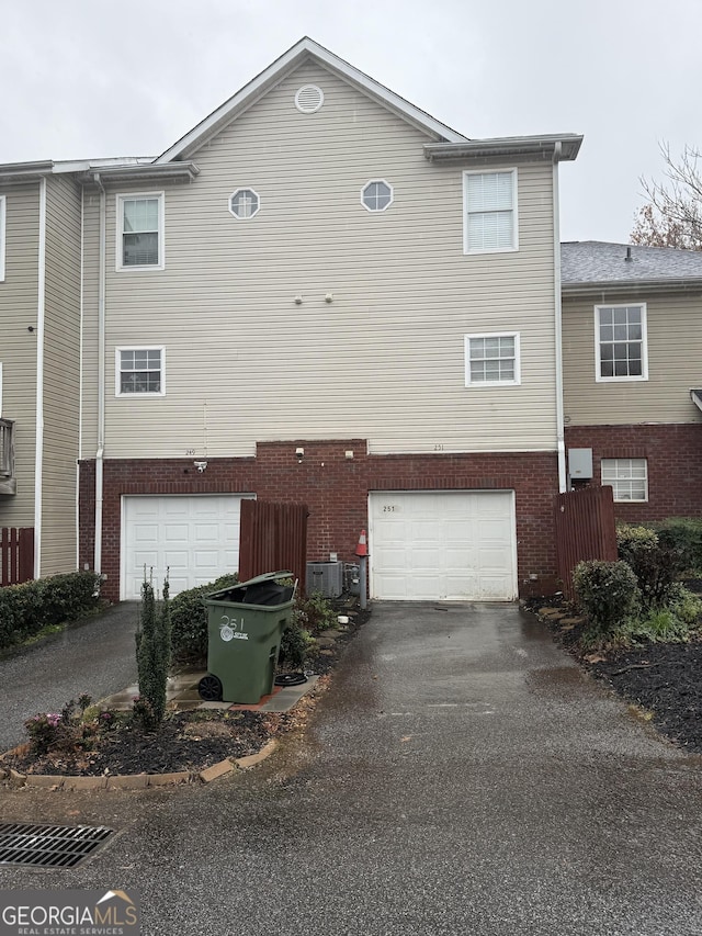 view of front of home featuring cooling unit and a garage