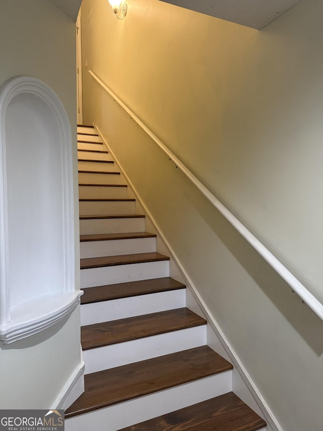 stairway featuring hardwood / wood-style floors