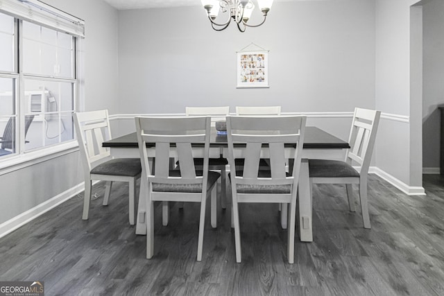 dining room with a chandelier and dark wood-type flooring