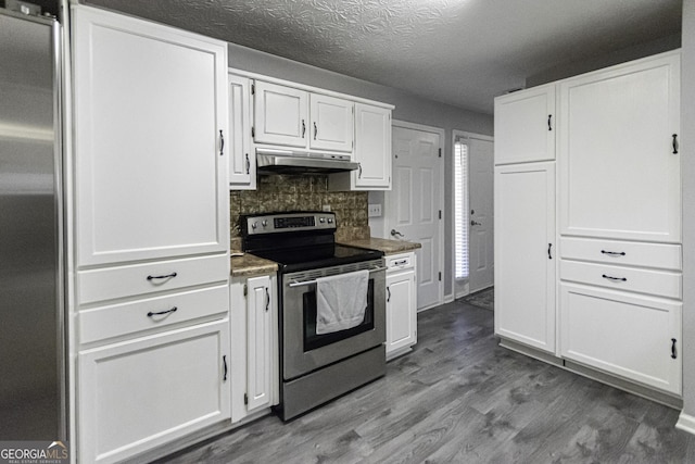 kitchen with hardwood / wood-style floors, stainless steel electric range, white cabinetry, and tasteful backsplash