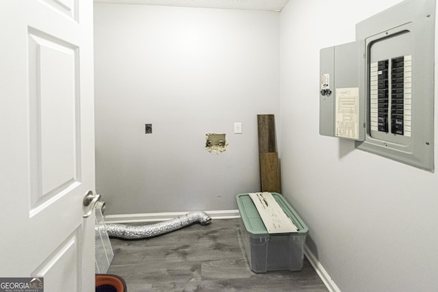 laundry area with wood-type flooring, electric panel, hookup for a washing machine, and electric dryer hookup