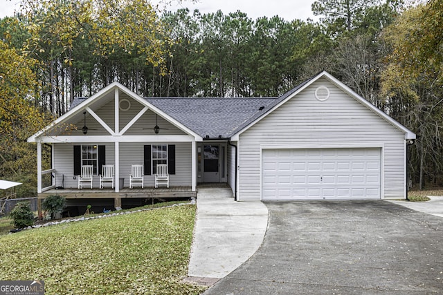 ranch-style home featuring covered porch, a garage, and a front lawn