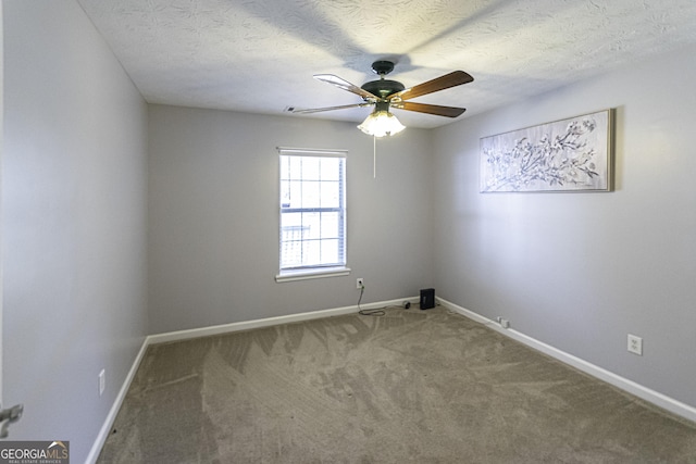 carpeted spare room with ceiling fan and a textured ceiling