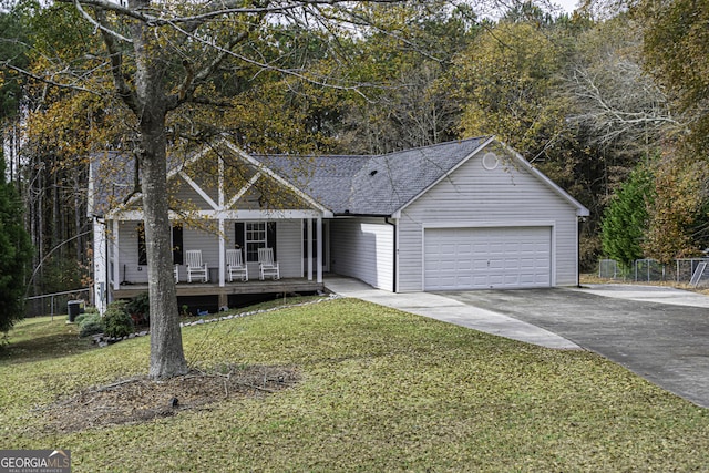 ranch-style house with covered porch, a garage, and a front lawn