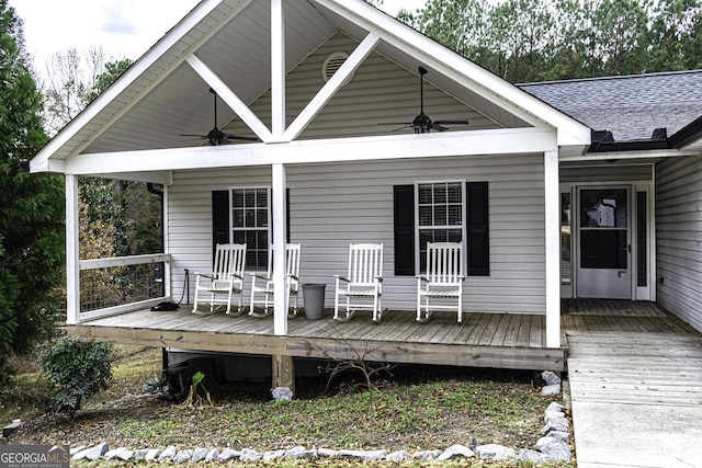 wooden terrace with ceiling fan and covered porch