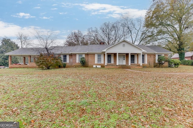 ranch-style home with a porch and a front yard