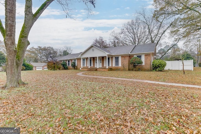 ranch-style home featuring a porch and a front lawn