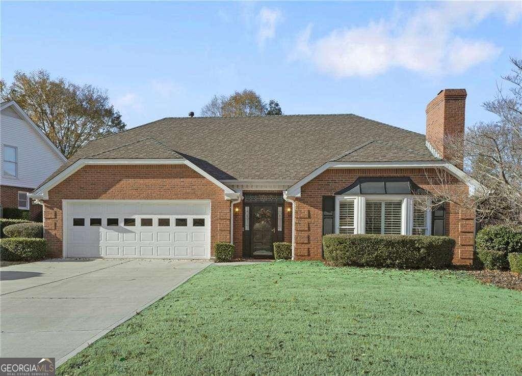 view of front facade with a front lawn and a garage