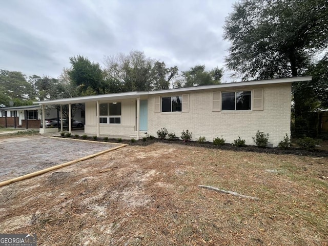 ranch-style house featuring a carport