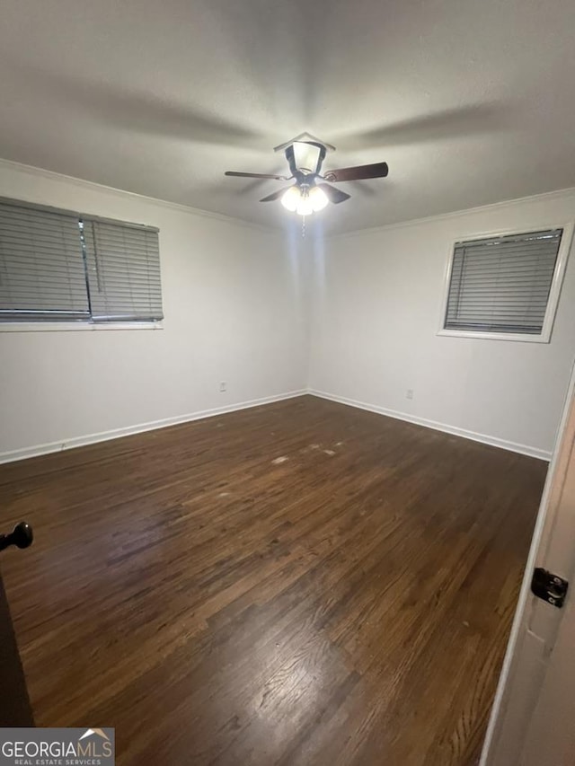 spare room with crown molding, ceiling fan, and dark hardwood / wood-style floors