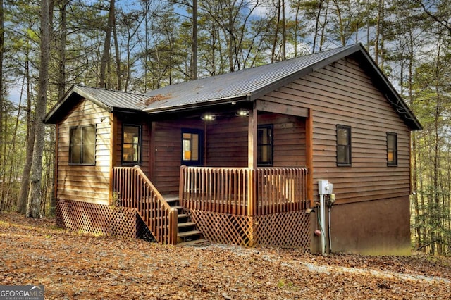 chalet / cabin with a porch and metal roof