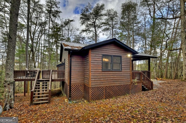 view of property exterior featuring a wooden deck