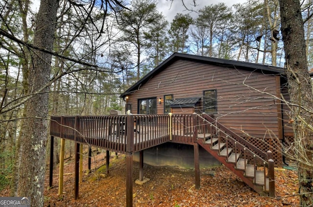 back of house with a wooden deck