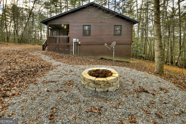 back of property with a fire pit