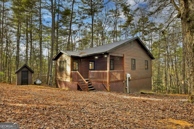 ranch-style home with a shed and a deck