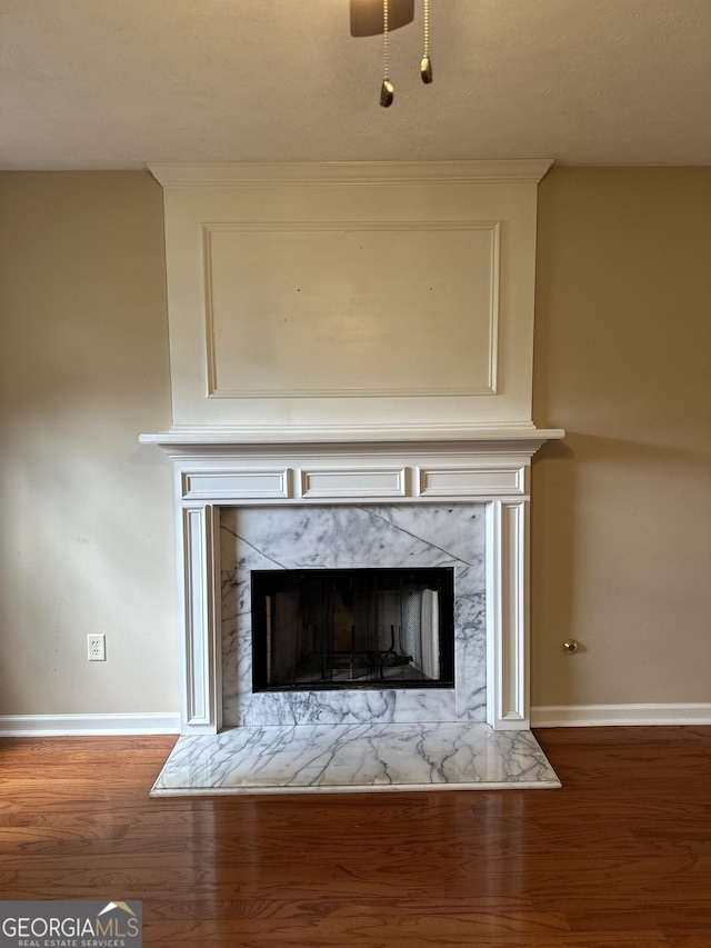 room details with a textured ceiling, wood-type flooring, and a fireplace