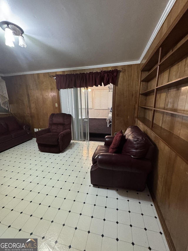 living area featuring built in shelves, wood walls, and ornamental molding