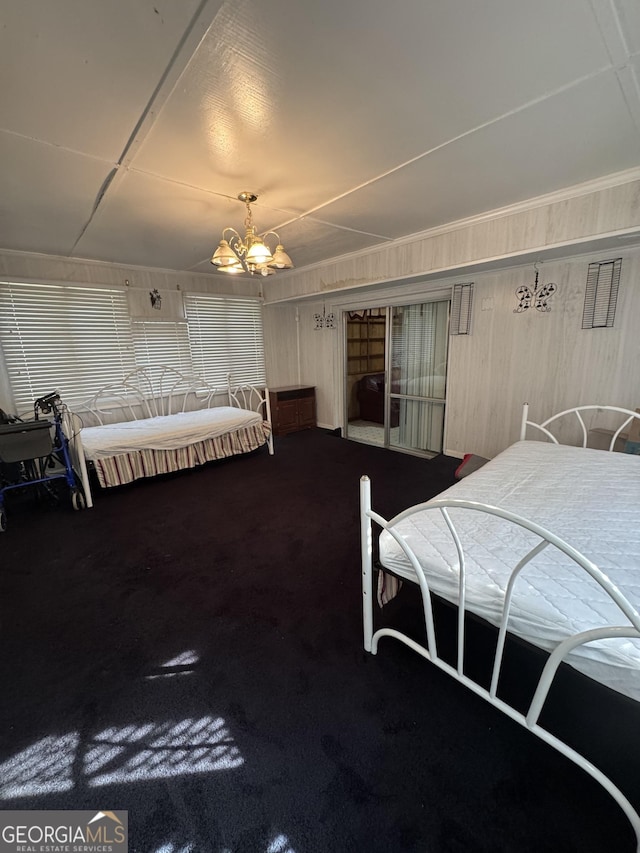 carpeted bedroom featuring a notable chandelier