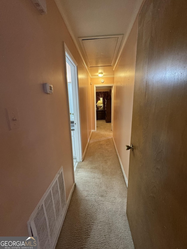 hall featuring light carpet and ornamental molding