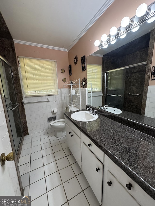 bathroom with an enclosed shower, tile patterned floors, tile walls, and crown molding