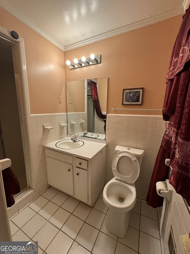 bathroom with vanity, tile patterned floors, crown molding, toilet, and tile walls