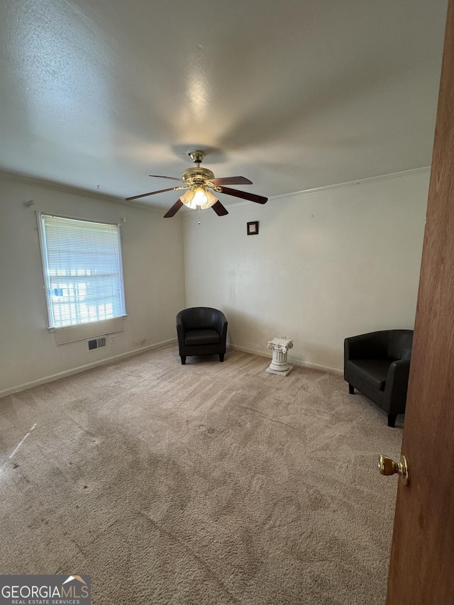 unfurnished room featuring ceiling fan, light colored carpet, and a textured ceiling