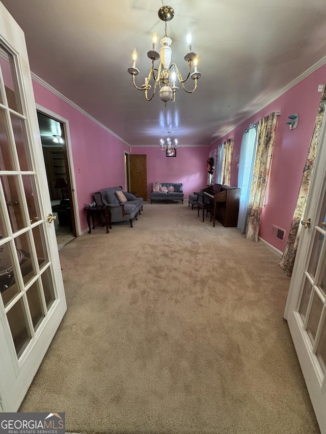 carpeted dining space featuring ornamental molding and a notable chandelier