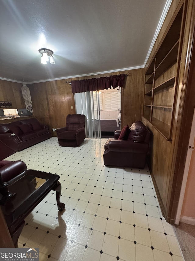 living room with crown molding and wooden walls