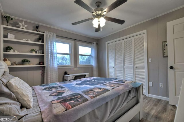 bedroom with a closet, ceiling fan, hardwood / wood-style floors, and crown molding