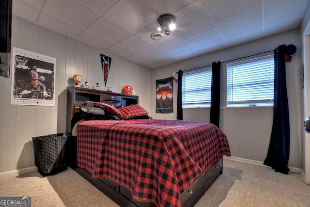 bedroom with carpet and a paneled ceiling