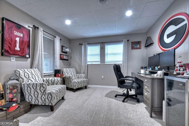 carpeted office space with a drop ceiling