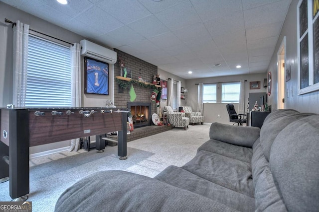 living room with a wall mounted air conditioner, carpet flooring, and a brick fireplace