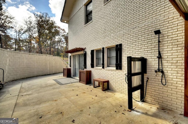 view of side of property with a patio