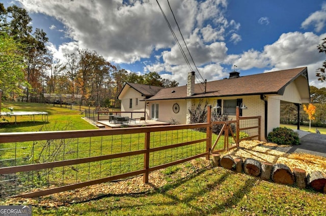 exterior space featuring a lawn and a trampoline