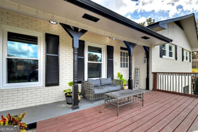 deck with a porch and an outdoor hangout area