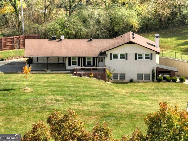 back of house featuring a yard and a carport