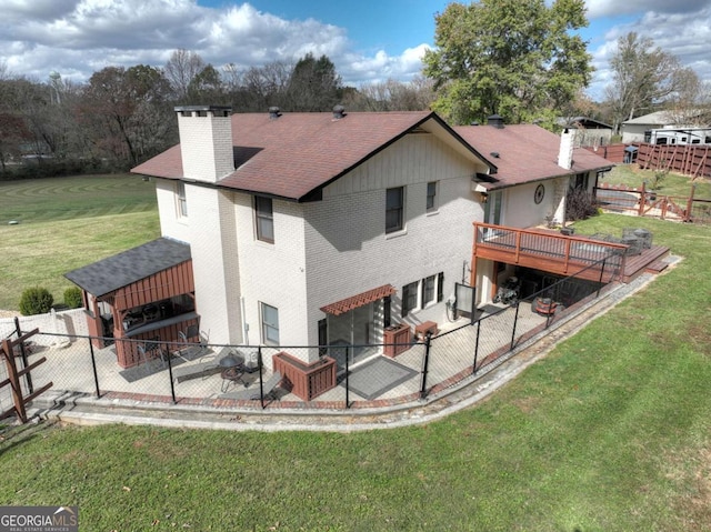 rear view of property featuring a yard and a wooden deck