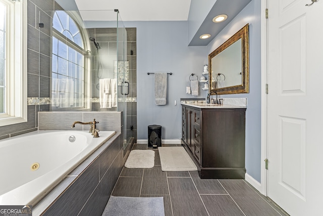 bathroom with vanity and independent shower and bath