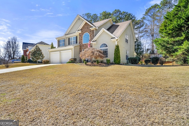 view of front of home with an attached garage, driveway, fence, and a front yard