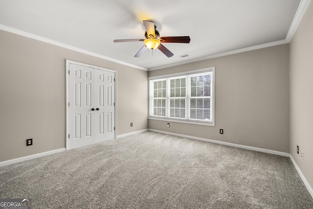 unfurnished bedroom featuring ornamental molding, carpet flooring, visible vents, and baseboards