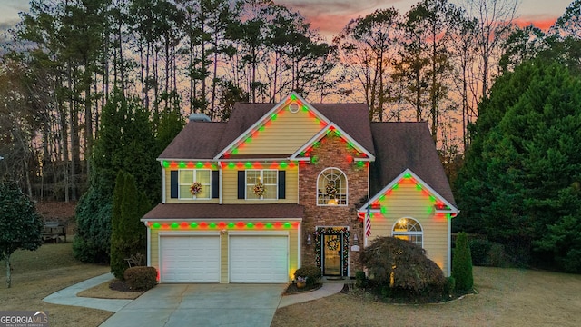 view of front of property featuring a yard and a garage