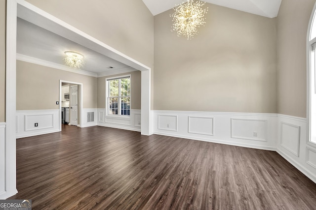 empty room with dark wood-style flooring, visible vents, crown molding, and an inviting chandelier