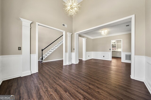 dining area with ornate columns, crown molding, dark wood-type flooring, and vaulted ceiling