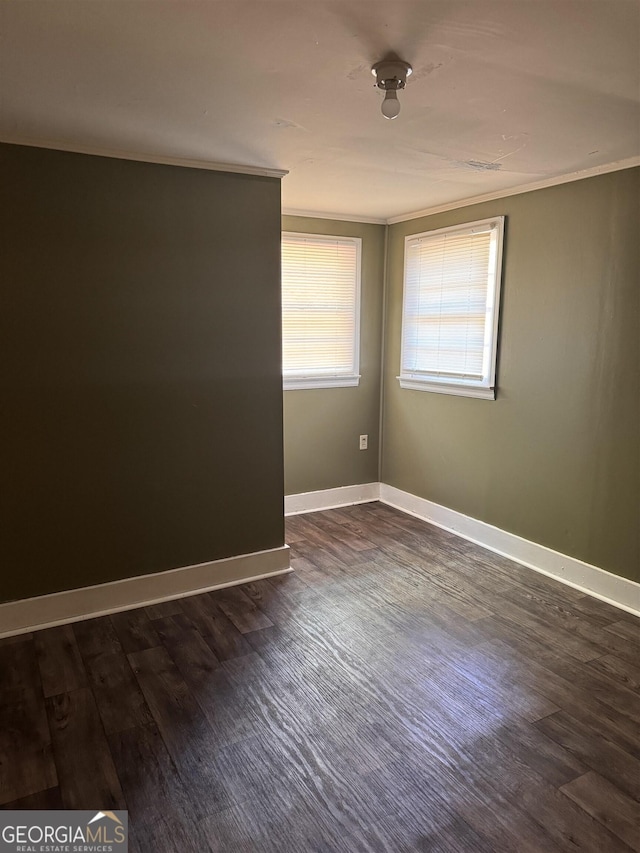 unfurnished room with dark hardwood / wood-style flooring and ornamental molding