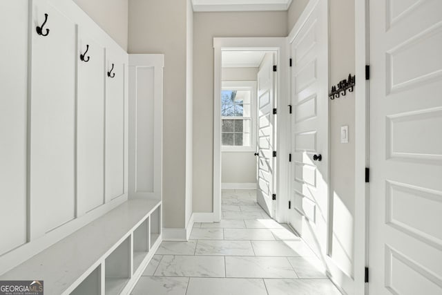 mudroom with baseboards and marble finish floor