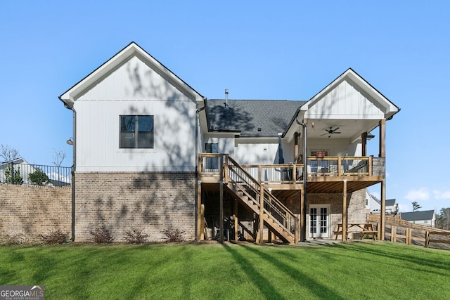 back of property with stairs, a yard, brick siding, and a wooden deck