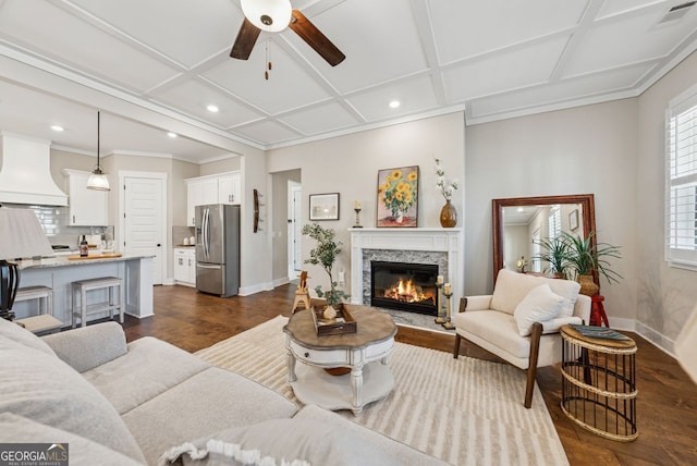 living area with visible vents, coffered ceiling, and baseboards